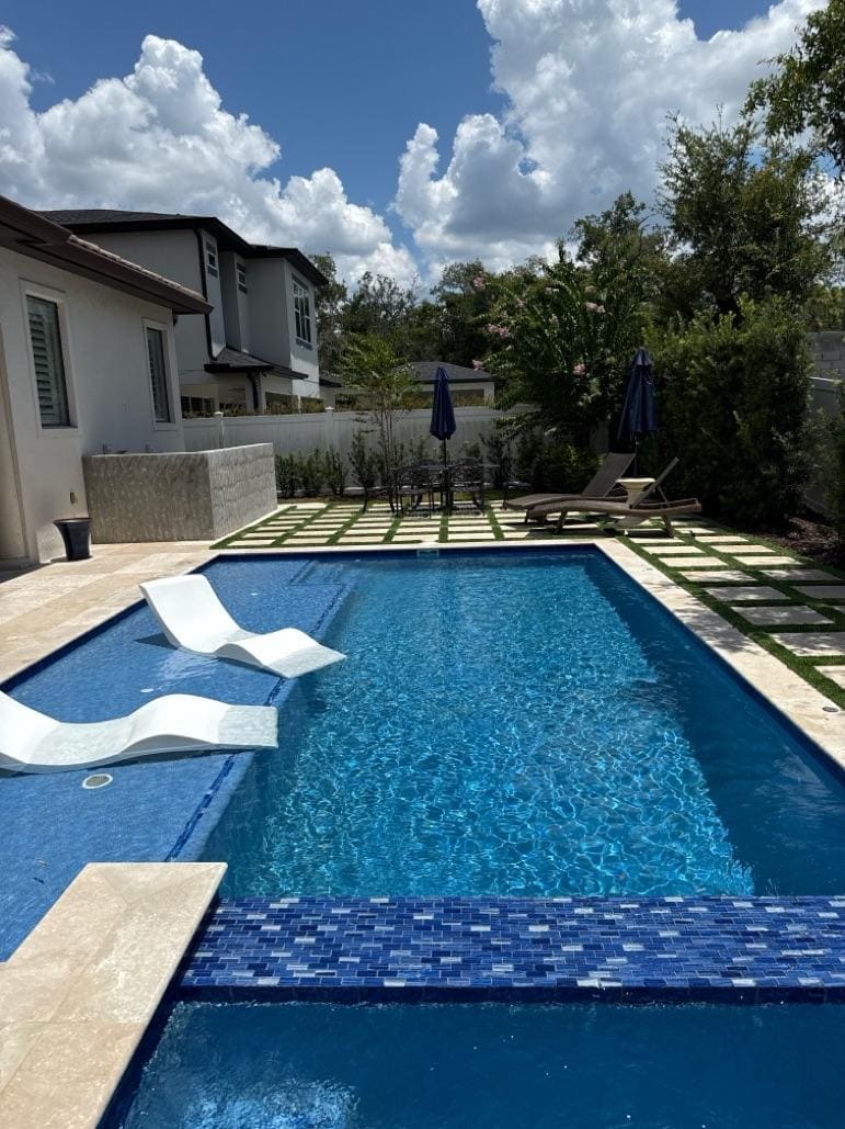 Professional pool service team working on a clean Orlando swimming pool